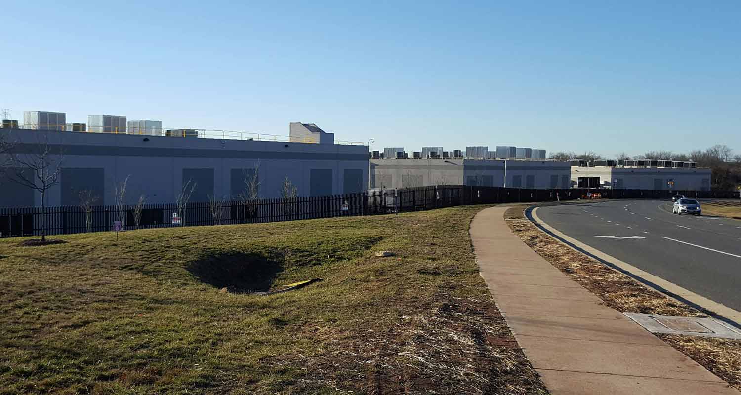 A row of three Amazon Web Services data centers in Ashburn, Virginia