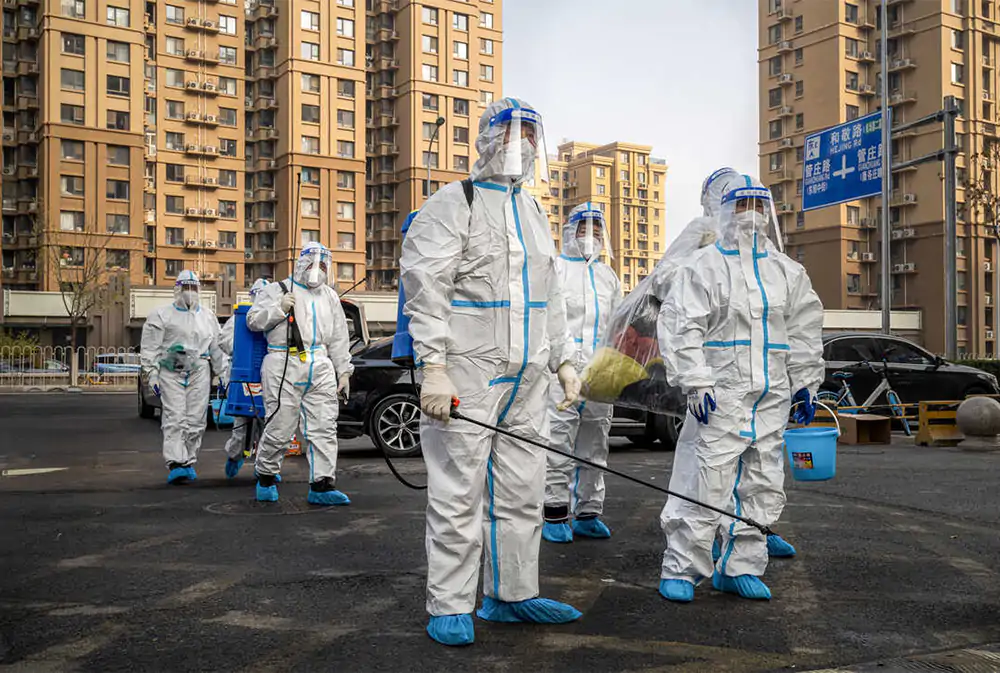 Workers wear protective hazmat suits in a neighborhood in Beijing during a lockdown in November 2022