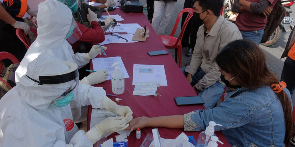 Health officials taking rapid test samples from people for screening COVID-19 in Penatih, Denpasar, Bali