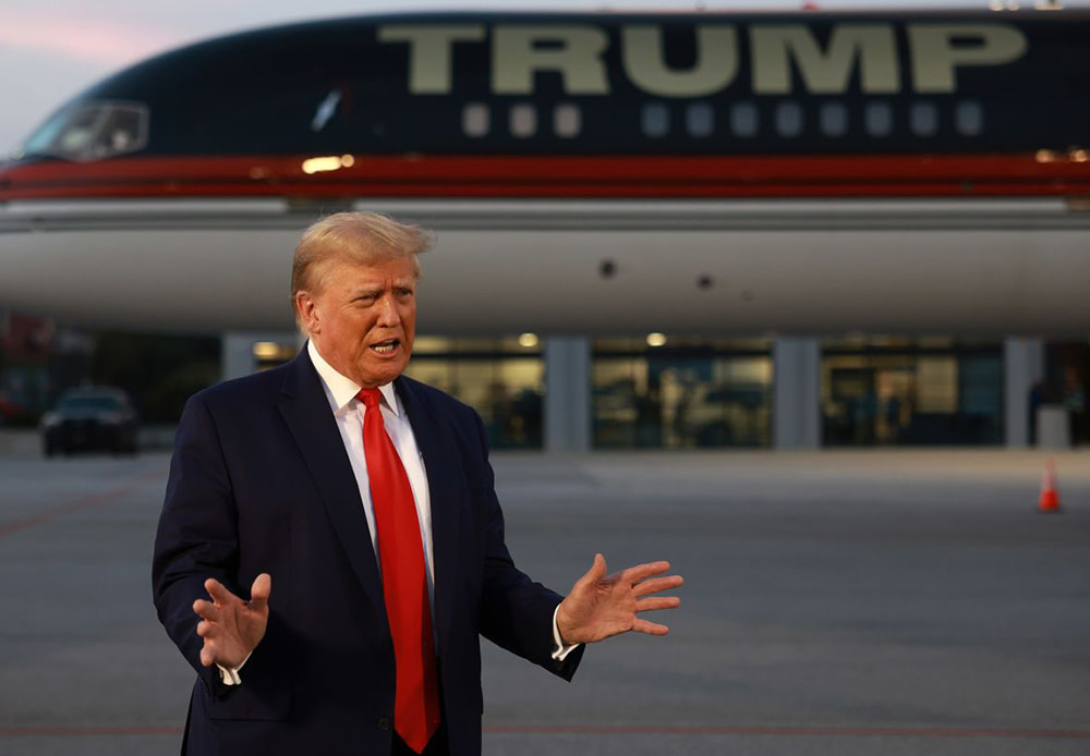 Donald Trump speaks to the media at Hartsfield-Jackson Atlanta International Airport after surrendering at the Fulton County jail