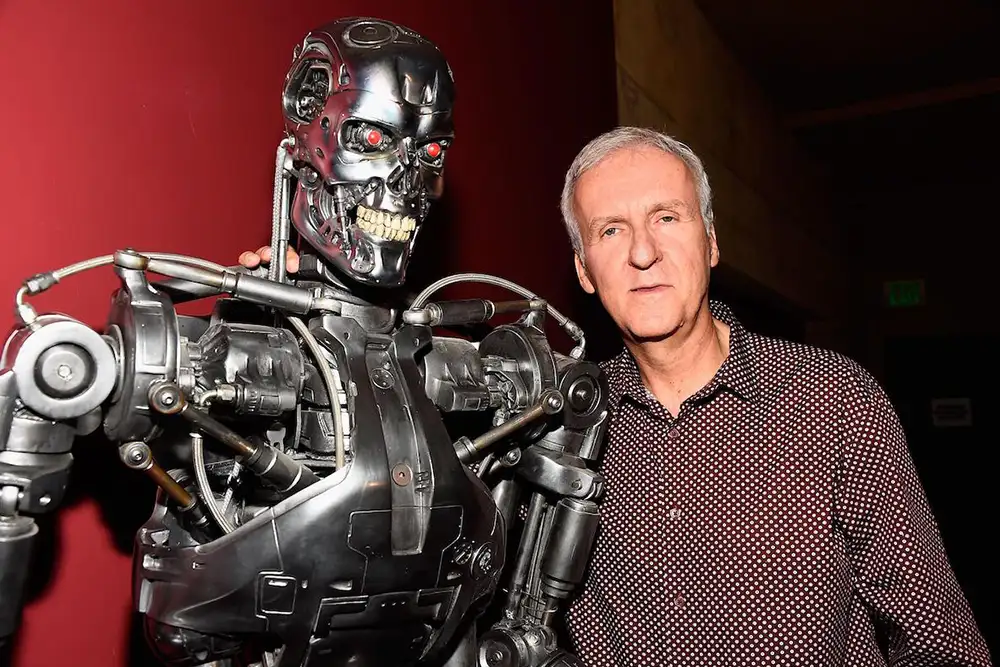 James Cameron posing next to a Model 101 or the T-800, the name of a Terminator in the franchise portrayed by actor Arnold Schwarzenegger