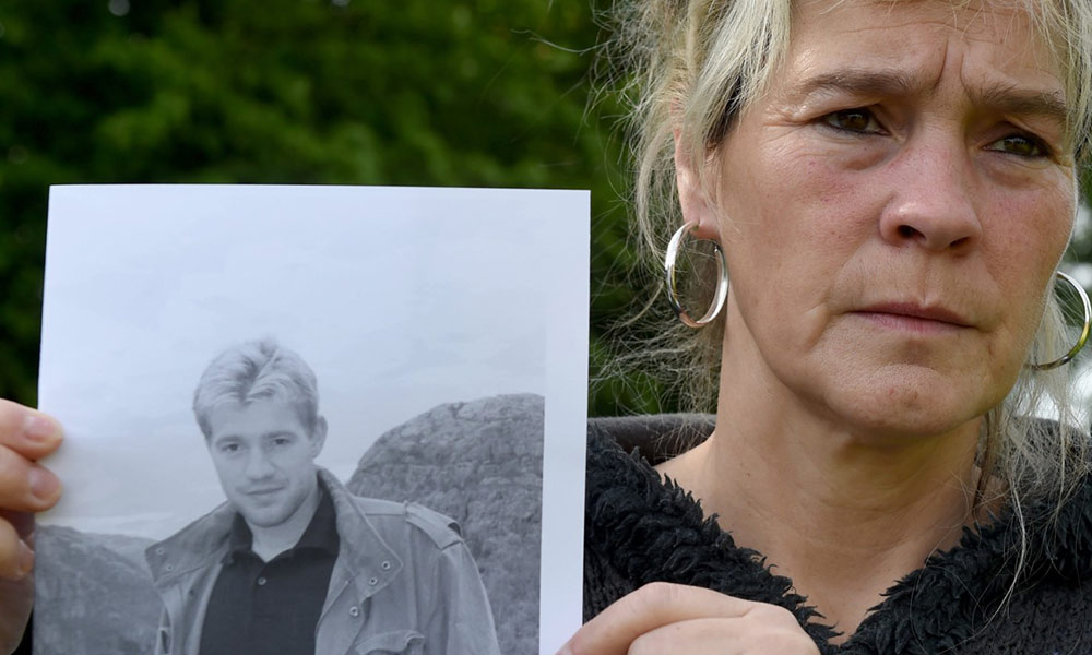 Lars Mittank mother, Sandra Mittank, holding a photo of his only son