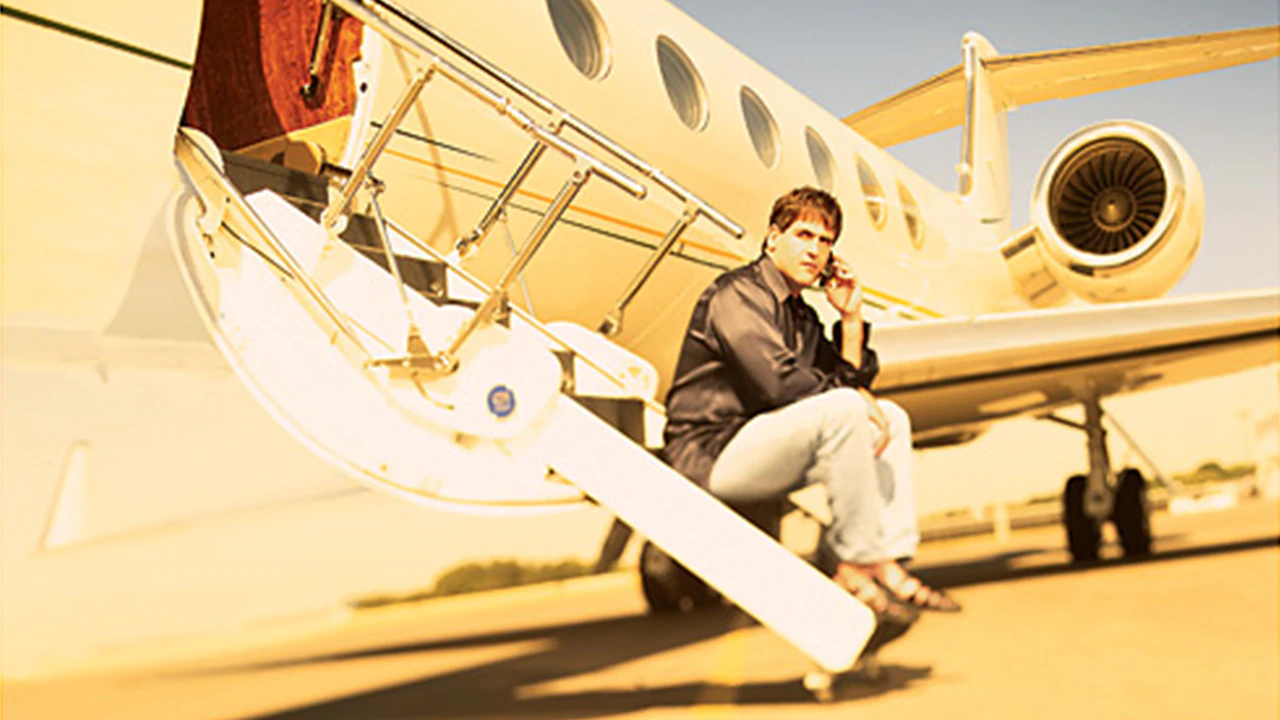 Mark Cuban sits on the steps of his Gulfstream V jet, which he bought online for $40 million