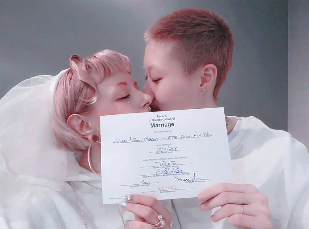 Etta Ng Chok Lam kisses her bride, Andi Autumn