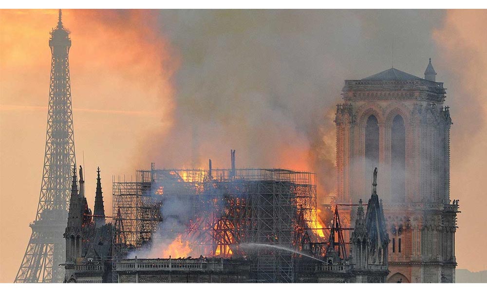 Thick smoke and flames were leaping off Notre-Dame cathedral into the Paris sky