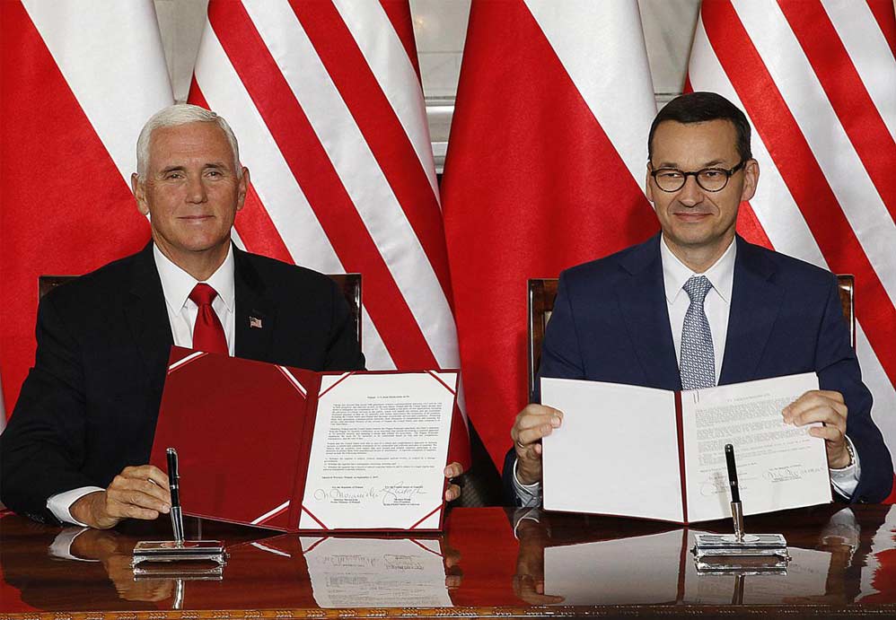 U.S. Vice President Mike Pence and Polish Prime Minister Mateusz Morawiecki display an agreement they signed in Warsaw, Poland, on Septerber 2, 2019