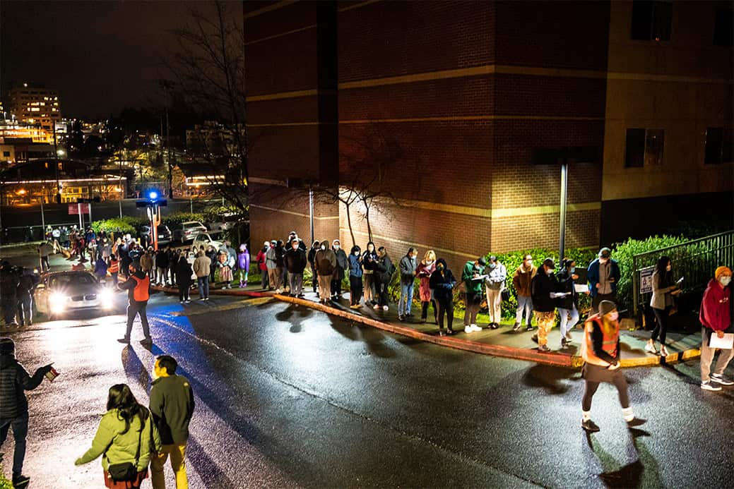 Hundreds of people wait in line for a last-minute COVID-19 vaccine event at Seattle University.